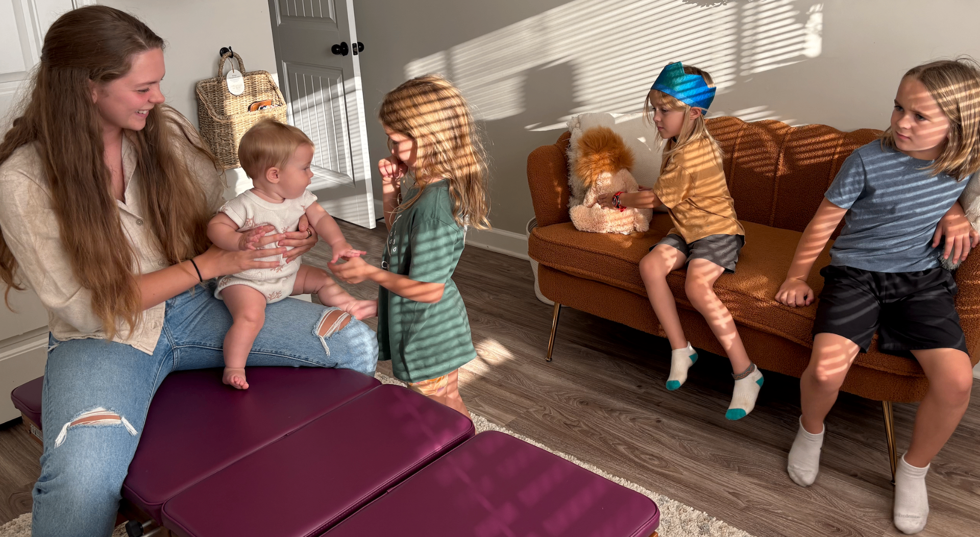 Dr. Shannon welcoming children and their mother in the chiropractic office